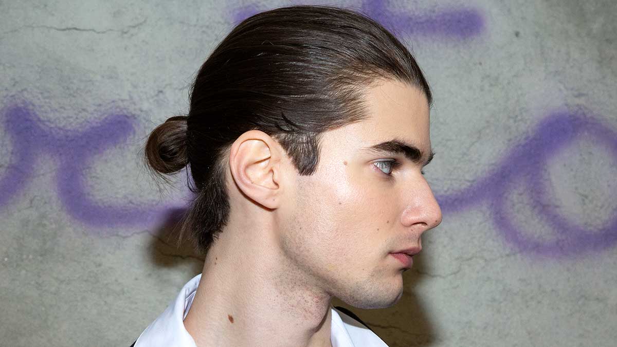 Tendenze capelli uomo autunno inverno 2020 2021. Capelli di media lunghezza con la codina (ma senza il nodo in alto) Sfilata Fabio Quaranta - Foto Charlotte Mesman
